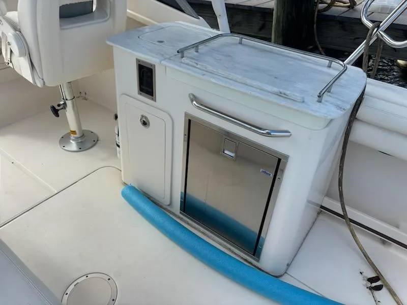 Slide: The Image of 2016 Grady-White Freedom 275 boat interior with seating and storage area. - 19