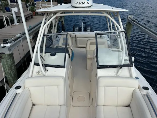 Slide: The Image of 2016 Grady-White Freedom 275 boat with Garmin equipment, docked by the water. - 2