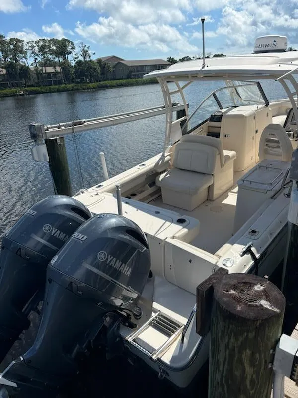 Slide: The Image of 2016 Grady-White Freedom 275 boat docked with twin Yamaha engines. - 22