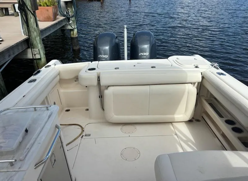 Slide: The Image of 2016 Grady-White Freedom 275 boat with dual 200 horsepower engines docked by the water. - 7