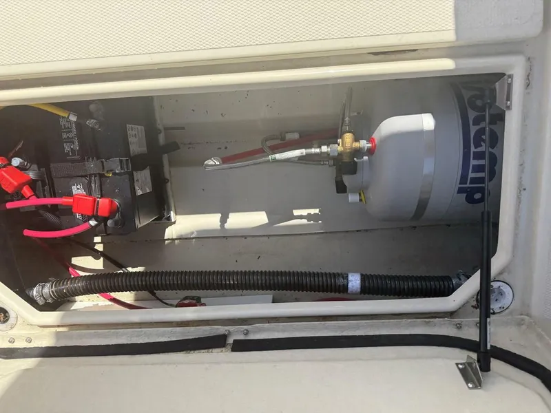 Slide: The Image of 2021 Ranger Tugs R-23 boat compartment with battery and propane tank. - 12