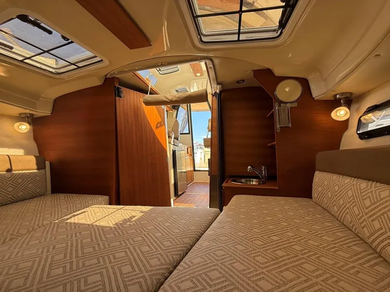 Slide: The Image of Interior of 2021 Ranger Tugs R-23 boat, featuring cozy cabin and modern amenities. - 16