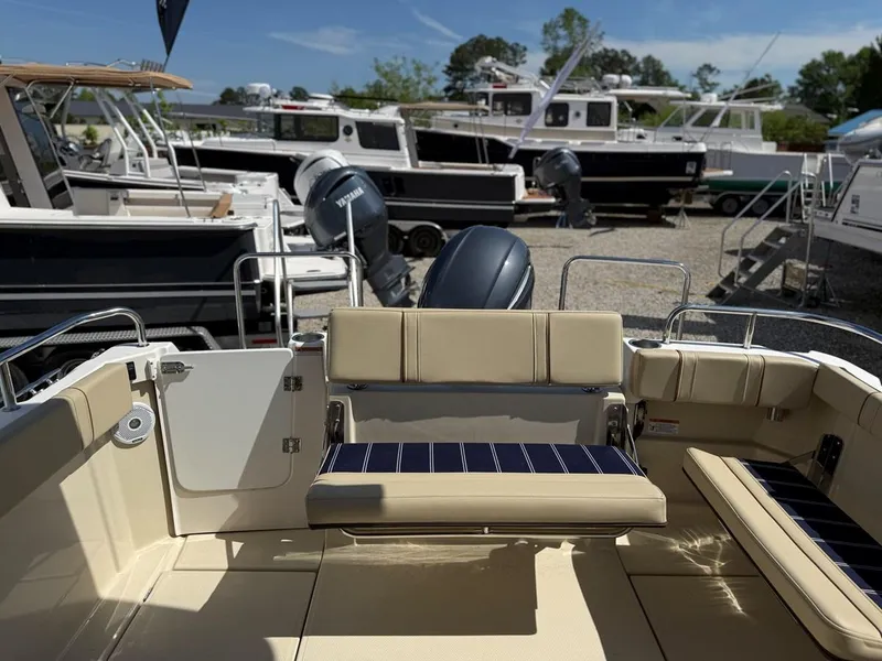 Slide: The Image of 2021 Ranger Tugs R-23 boat interior with seating, docked among other boats. - 4