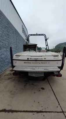 Slide: The Image of 2002 Malibu 23 LSV boat parked outside a building, rear view. - 10