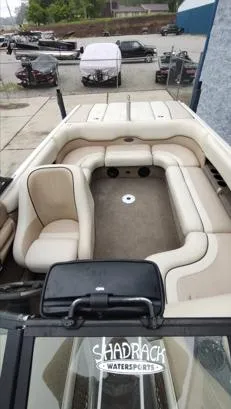 Slide: The Image of 2002 Malibu 23 LSV boat interior with beige seating, Shadrack Watersports logo visible. - 5