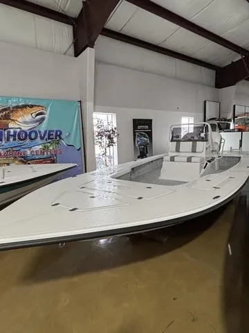 Slide: The Image of 2025 Majek 25 Xtreme boat displayed indoors at a marine center showroom. - 4