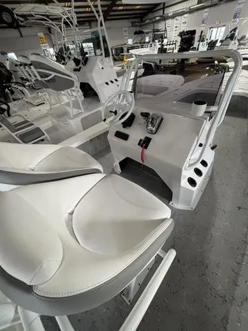 Slide: The Image of 2025 Majek 25 Xtreme boat interior with white seating and control panel. - 8