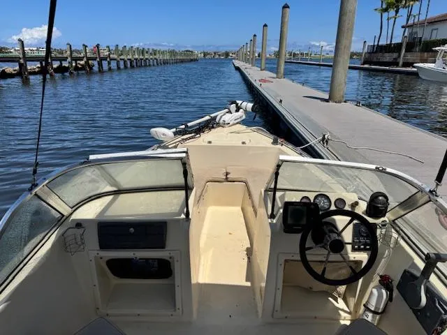 Slide: The Image of 1993 Key West 1720 DC boat docked at marina, clear blue sky, calm water. - 11