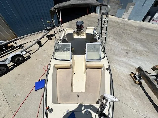 Slide: The Image of 1993 Key West 1720 DC boat with open deck, docked on concrete surface. - 15