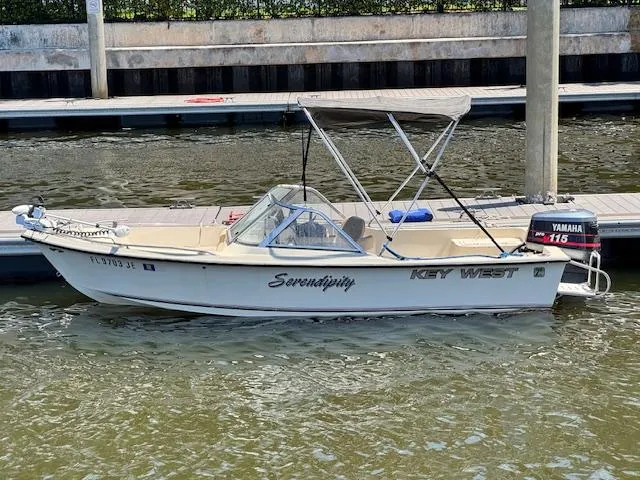 Slide: The Image of 1993 Key West 1720 DC boat docked, featuring Yamaha 115 outboard motor. - 2