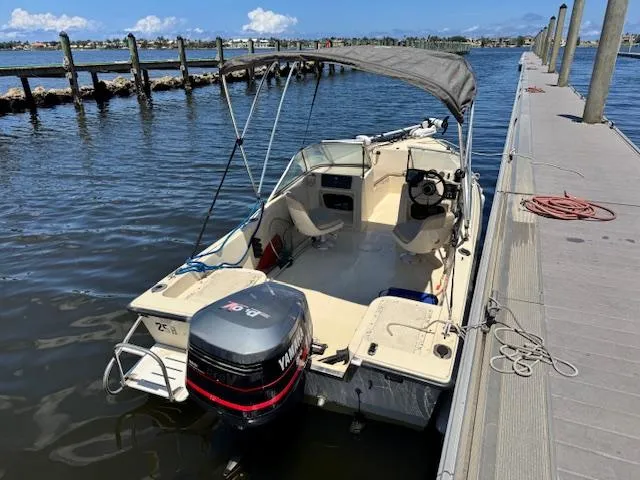 Slide: The Image of 1993 Key West 1720 DC boat docked with canopy and Yamaha outboard motor. - 6