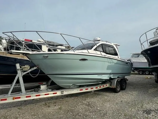 Slide: The Image of 2017 Cutwater C-24 boat on trailer, parked outdoors, side view. - 0