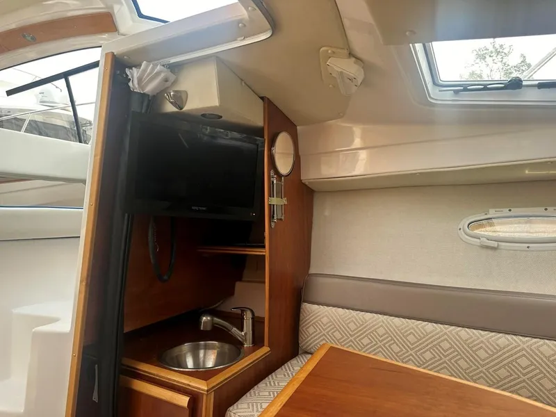 Slide: The Image of 2017 Cutwater C-24 cabin interior with sink, TV, and seating area. - 8