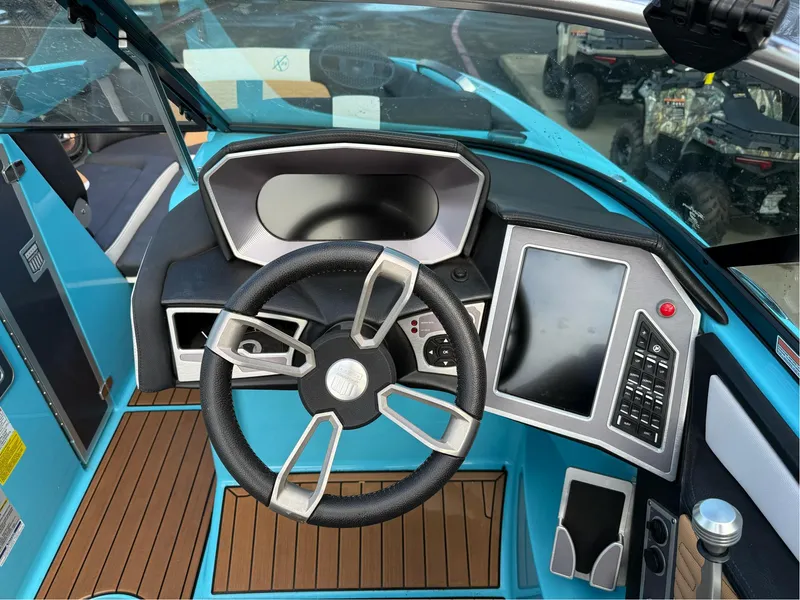 Slide: The Image of 2019 MasterCraft X24 boat dashboard with steering wheel and touchscreen controls. - 14