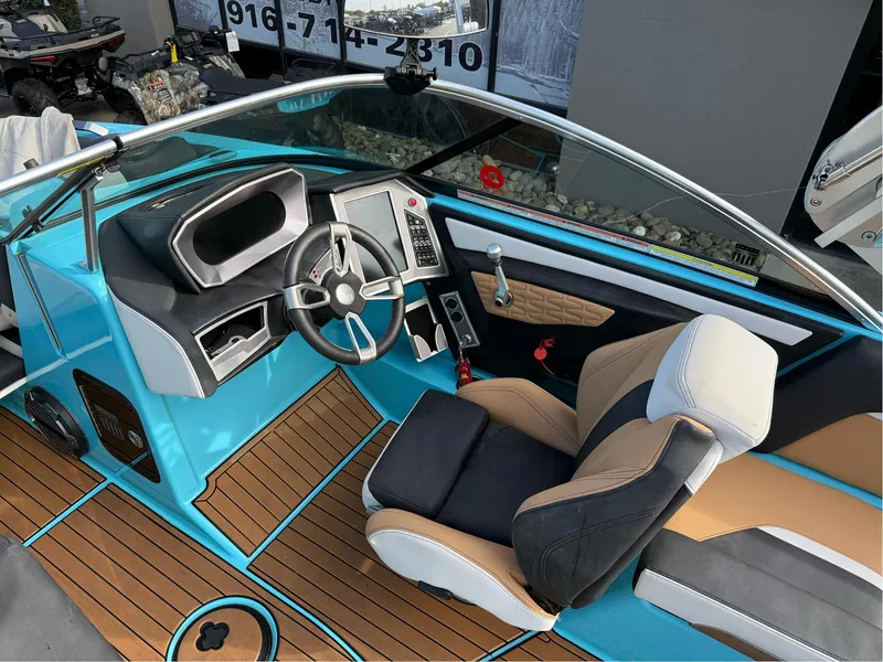 Slide: The Image of 2019 MasterCraft X24 boat interior with modern dashboard and stylish seating. - 15