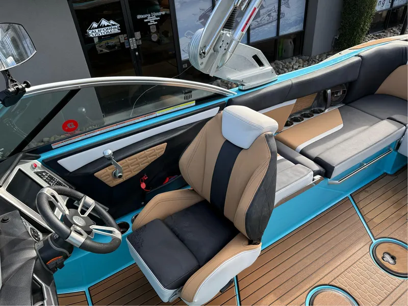 Slide: The Image of 2019 MasterCraft X24 boat interior with blue accents and modern seating design. - 16