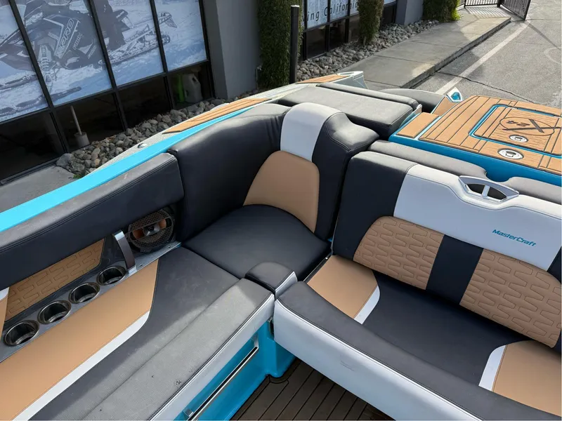 Slide: The Image of 2019 MasterCraft X24 boat interior with stylish seating and cup holders. - 20