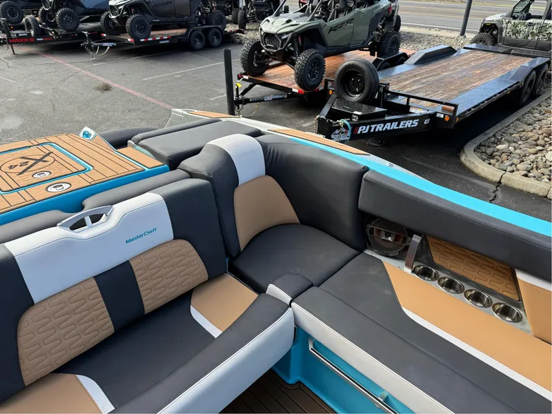 Slide: The Image of 2019 MasterCraft X24 boat interior with luxurious seating and cup holders. - 22