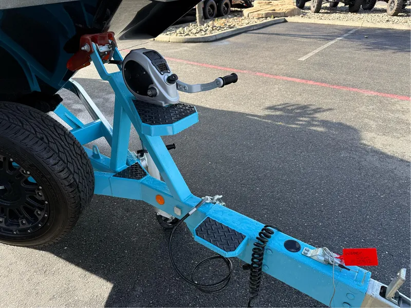 Slide: The Image of Trailer hitch of a 2019 MasterCraft X24 boat in a parking lot. - 8