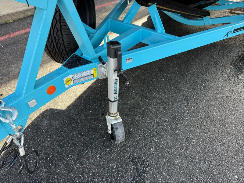 Slide: The Image of Blue trailer for 2019 MasterCraft X24 with Fulton jack on asphalt. - 9