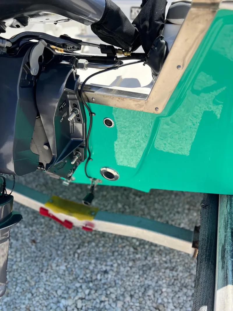 Slide: The Image of 2025 Key West 1720 Center Console boat engine detail on gravel surface. - 10