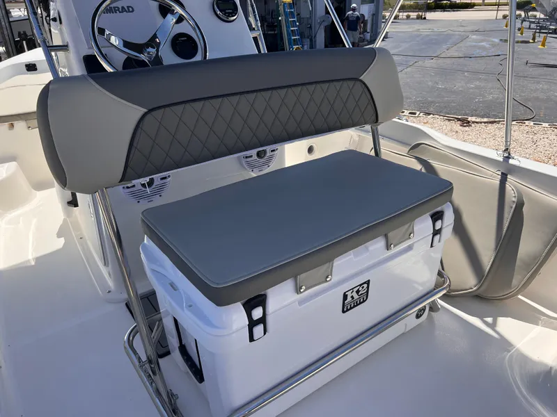 Slide: The Image of 2025 Key West 1720 Center Console boat with cushioned seating and cooler storage. - 15