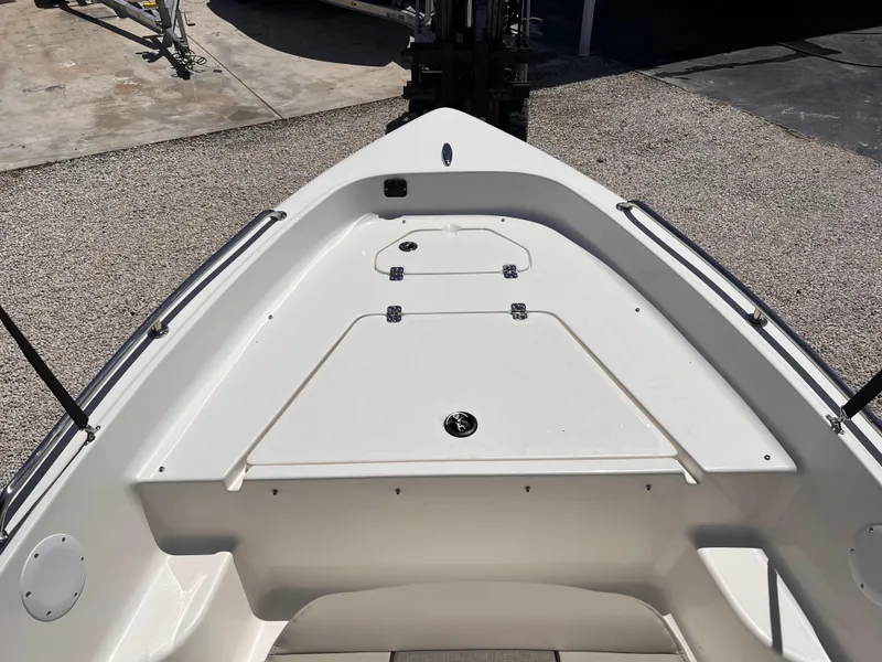 Slide: The Image of 2025 Key West 1720 Center Console boat deck, featuring storage compartments and clean design. - 18