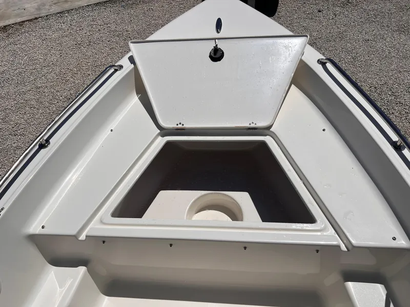 Slide: The Image of 2025 Key West 1720 Center Console boat bow with open storage compartment. - 19