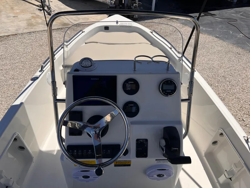 Slide: The Image of 2025 Key West 1720 Center Console boat dashboard with steering wheel and gauges. - 23