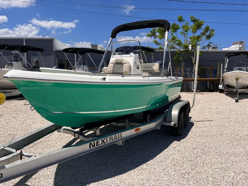 Slide: The Image of 2025 Key West 1720 Center Console boat on trailer, vibrant green hull, sunny day. - 3