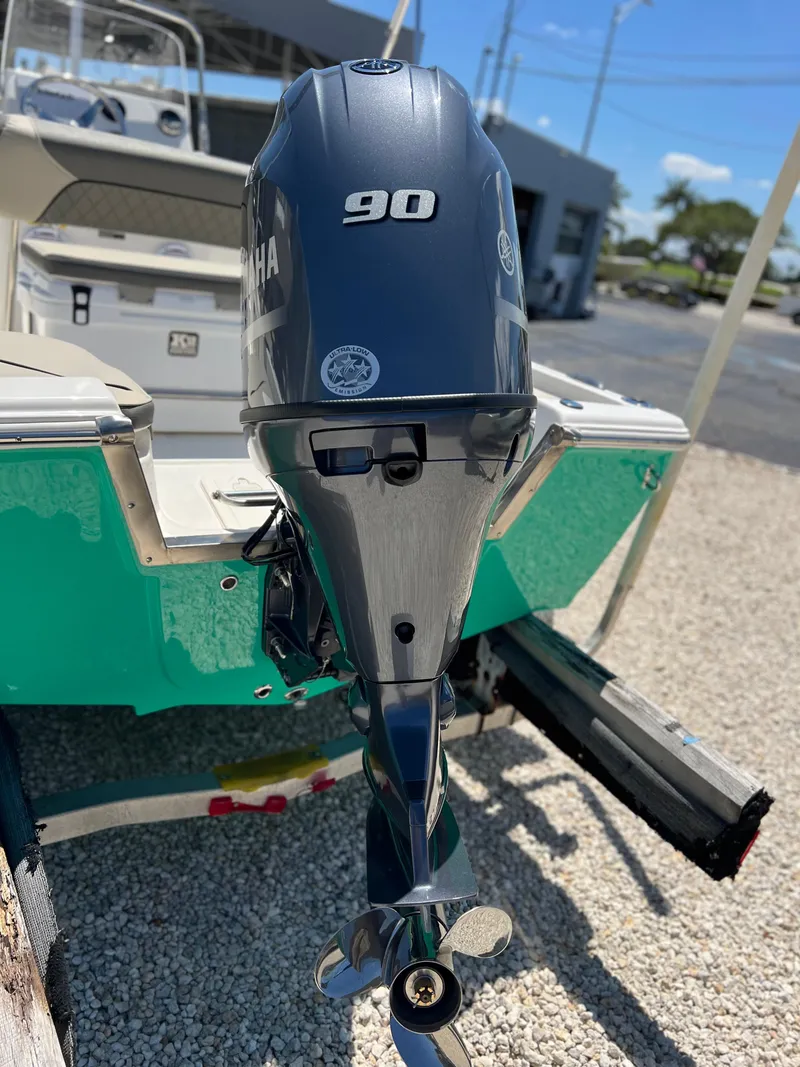 Slide: The Image of 2025 Key West 1720 Center Console with Yamaha 90 outboard motor, parked on gravel. - 8