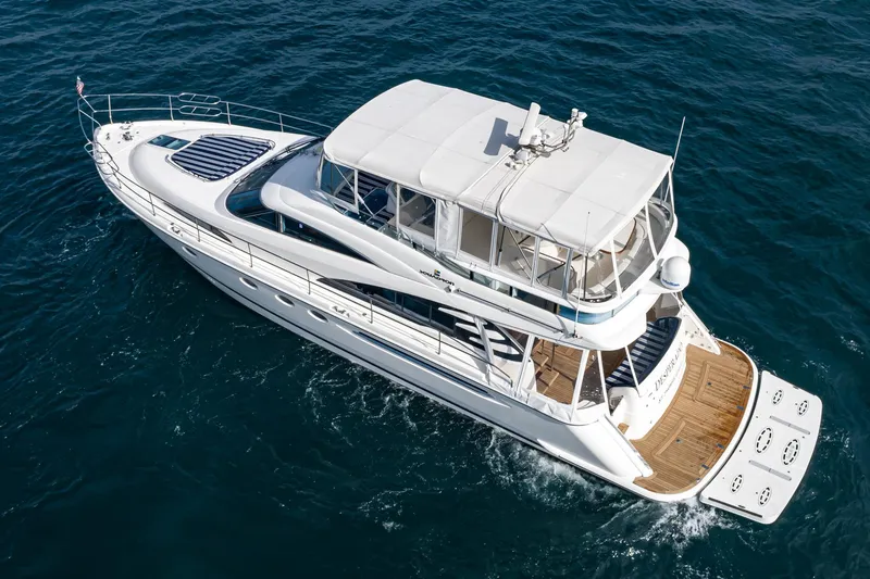 Slide: The Image of 2002 Fairline Squadron 58 yacht cruising on open water, aerial view. - 10