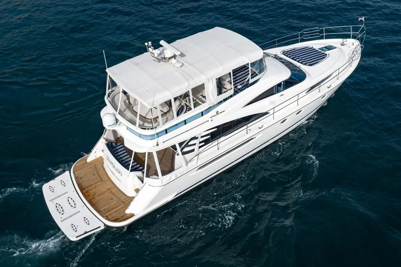 Slide: The Image of 2002 Fairline Squadron 58 yacht cruising on open water. - 11