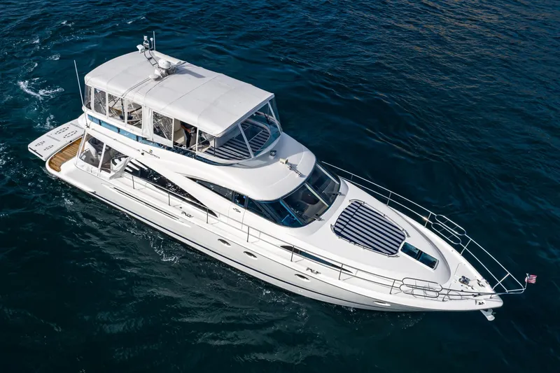 Slide: The Image of Luxury 2002 Fairline Squadron 58 yacht cruising on open water. - 12