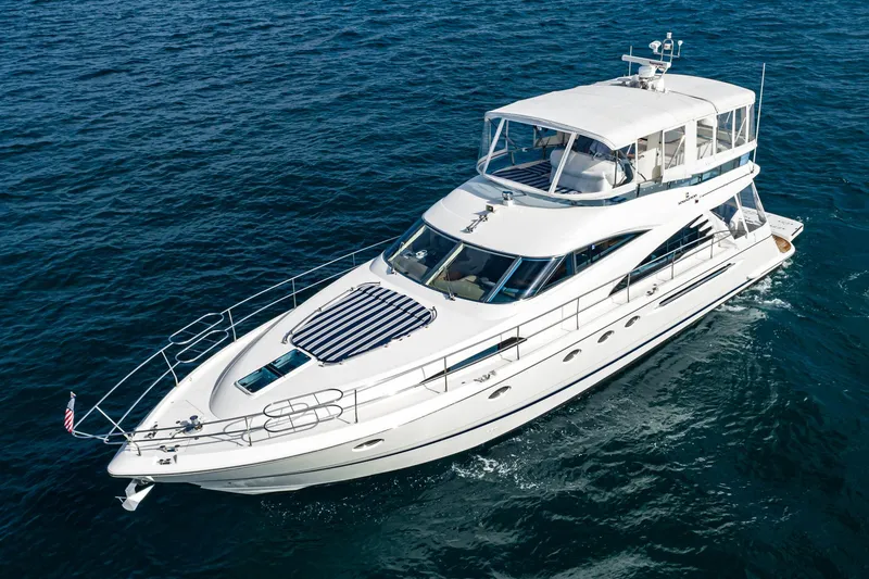 Slide: The Image of 2002 Fairline Squadron 58 yacht cruising on open water. - 13