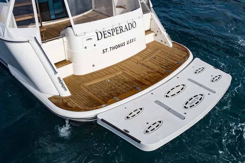Slide: The Image of Alt text: "2002 Fairline Squadron 58 yacht stern with wooden deck, named Desperado, in water." - 15