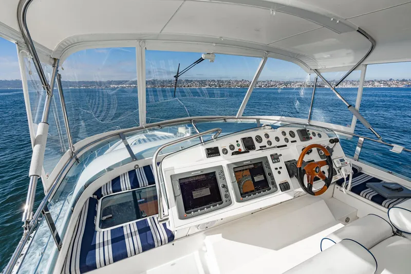 Slide: The Image of Cockpit of 2002 Fairline Squadron 58 yacht with ocean view and navigation equipment. - 17