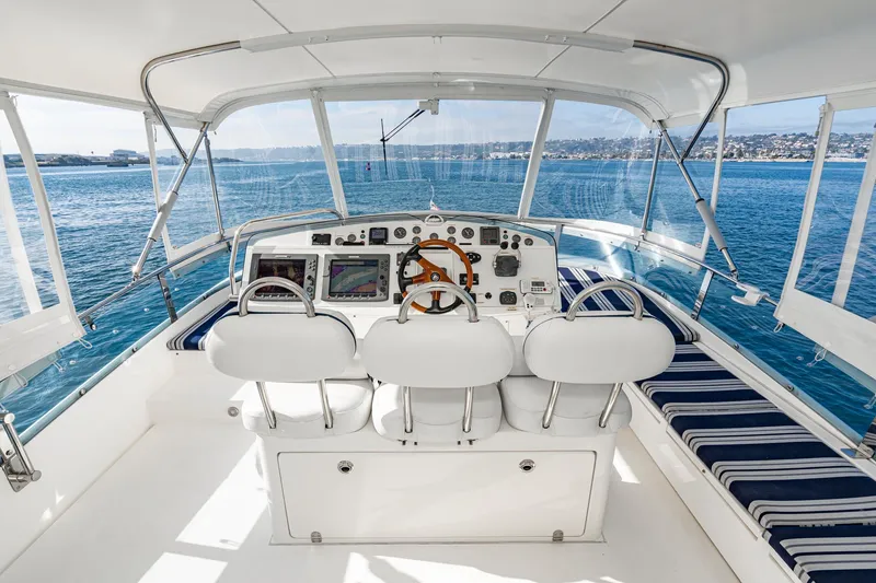 Slide: The Image of Cockpit of 2002 Fairline Squadron 58 yacht with ocean view and seating. - 18