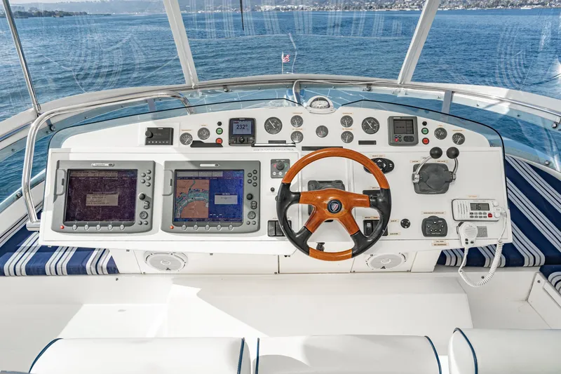 Slide: The Image of Helm of 2002 Fairline Squadron 58 yacht with navigation equipment and wooden steering wheel. - 19