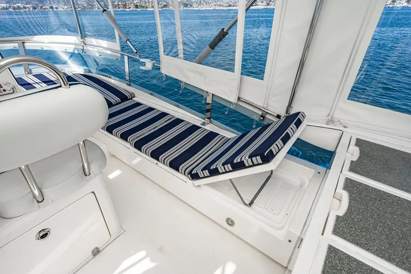 Slide: The Image of 2002 Fairline Squadron 58 yacht interior with striped seating and ocean view. - 21