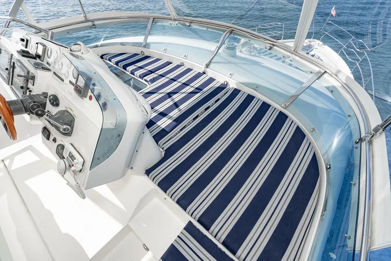 Slide: The Image of Cockpit view of 2002 Fairline Squadron 58 yacht with striped seating. - 22