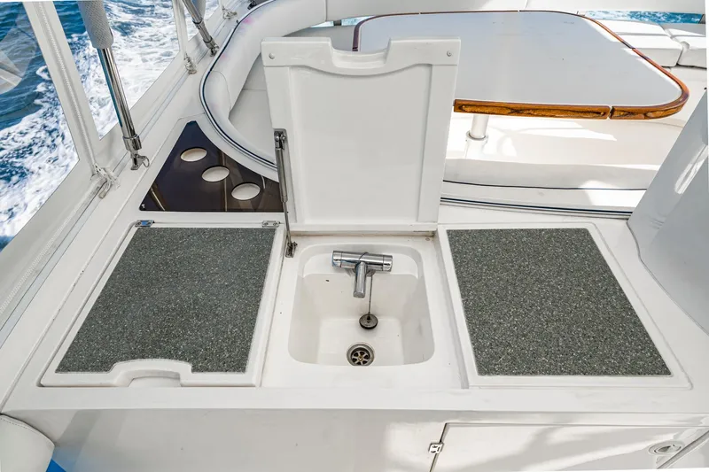 Slide: The Image of Outdoor sink area on 2002 Fairline Squadron 58 yacht, featuring a compact design. - 24