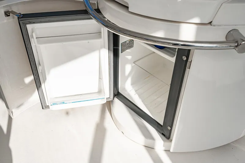 Slide: The Image of Open mini fridge on 2002 Fairline Squadron 58 yacht, showcasing interior storage space. - 26