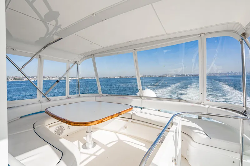 Slide: The Image of 2002 Fairline Squadron 58 yacht interior with ocean view and seating area. - 27