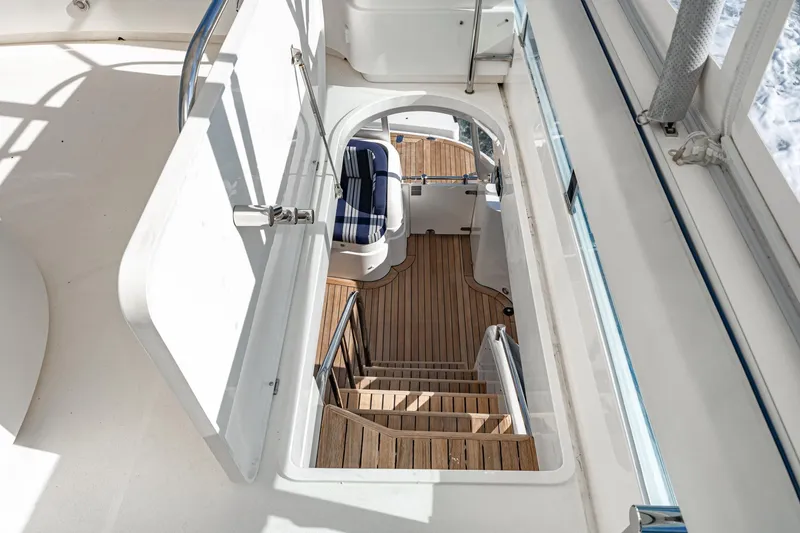 Slide: The Image of Staircase on 2002 Fairline Squadron 58 yacht with wooden steps and seating area. - 29