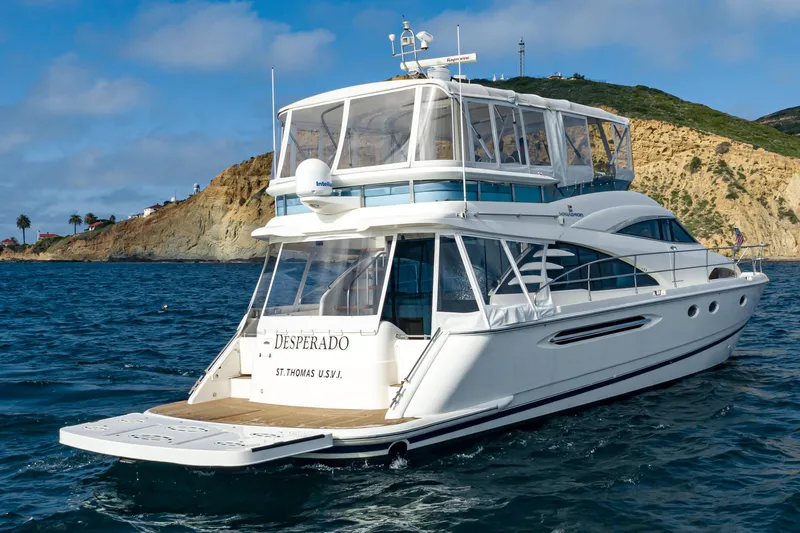 Slide: The Image of 2002 Fairline Squadron 58 yacht cruising near a scenic coastline. - 3