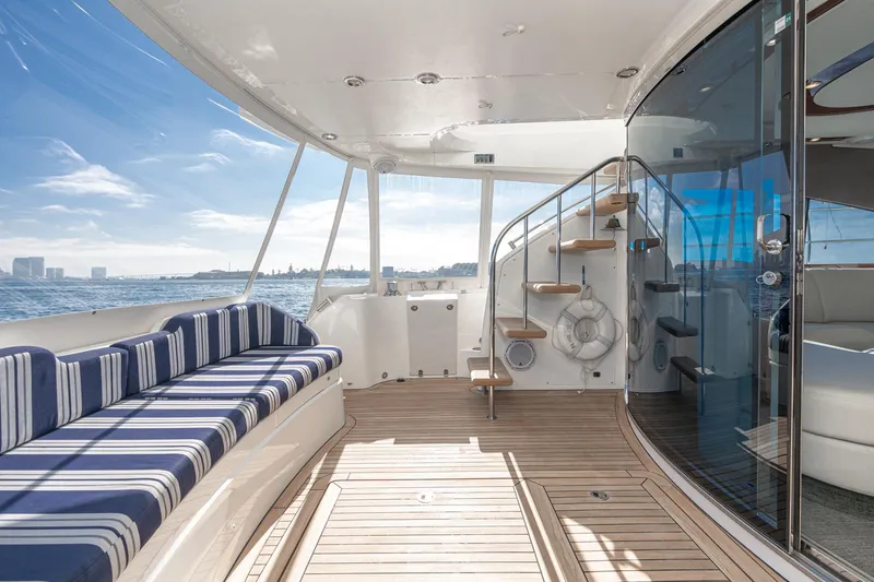 Slide: The Image of Luxurious 2002 Fairline Squadron 58 yacht deck with striped seating and ocean view. - 32