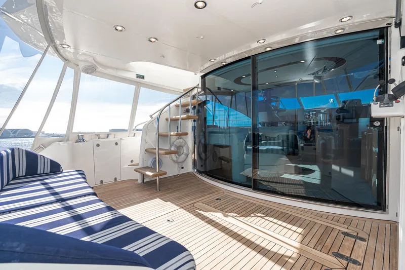 Slide: The Image of Luxurious 2002 Fairline Squadron 58 yacht interior with striped seating and wooden deck. - 36