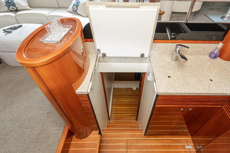Slide: The Image of Luxurious 2002 Fairline Squadron 58 yacht interior with elegant wood cabinetry and modern sink. - 45