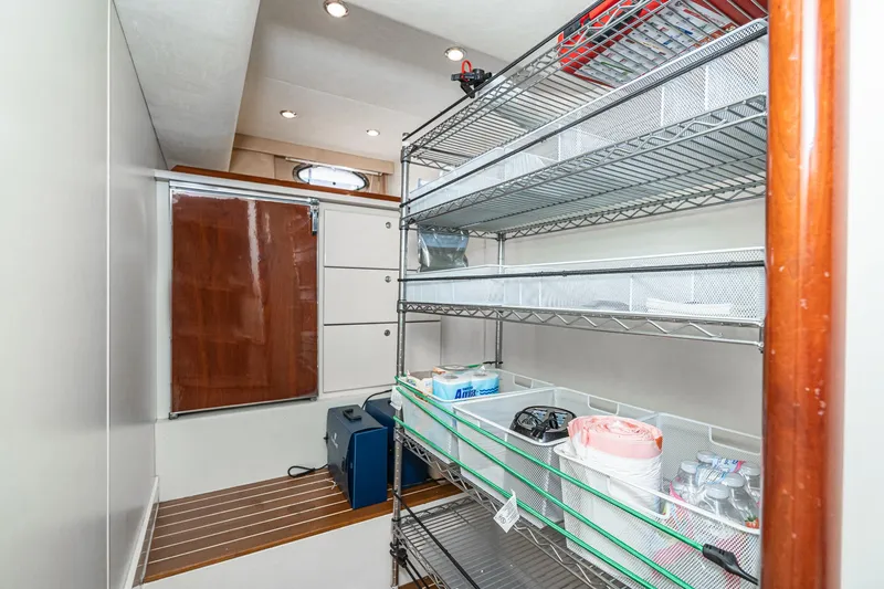 Slide: The Image of Storage area in a 2002 Fairline Squadron 58 yacht with metal shelves and organized supplies. - 46